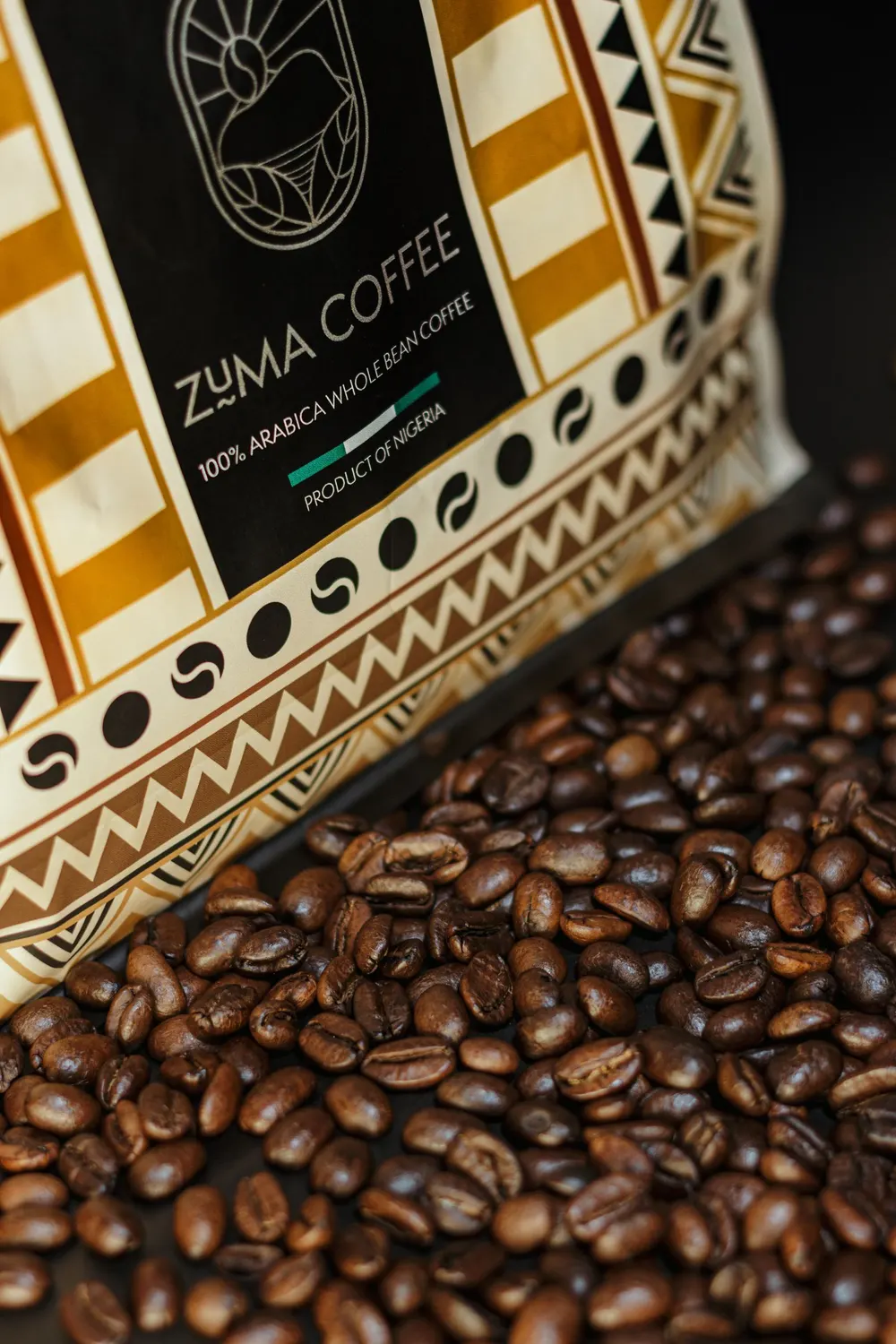 Ember & Oak coffee bag resting on freshly roasted beans